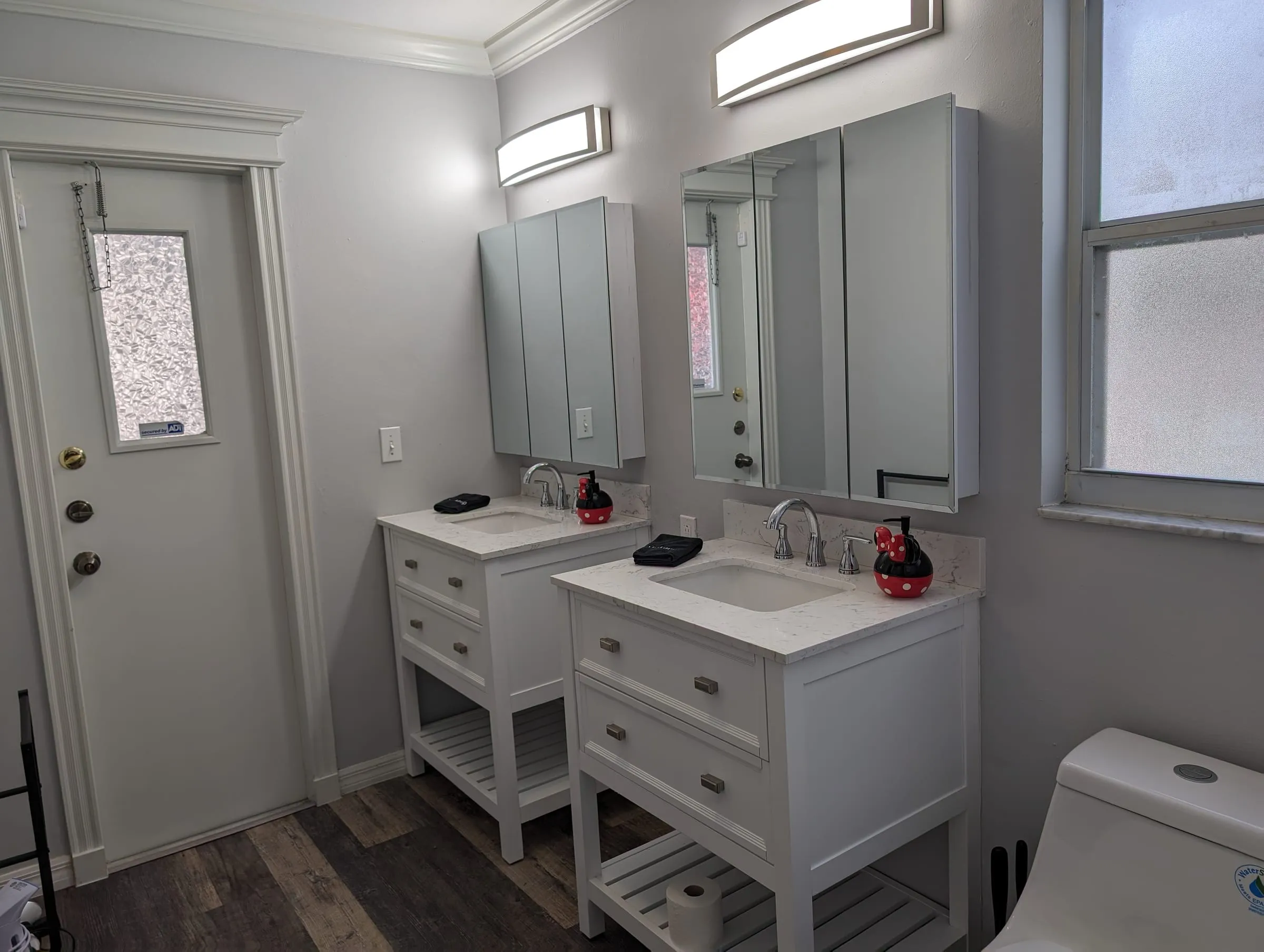 Wide view of the dual-vanity master bathroom