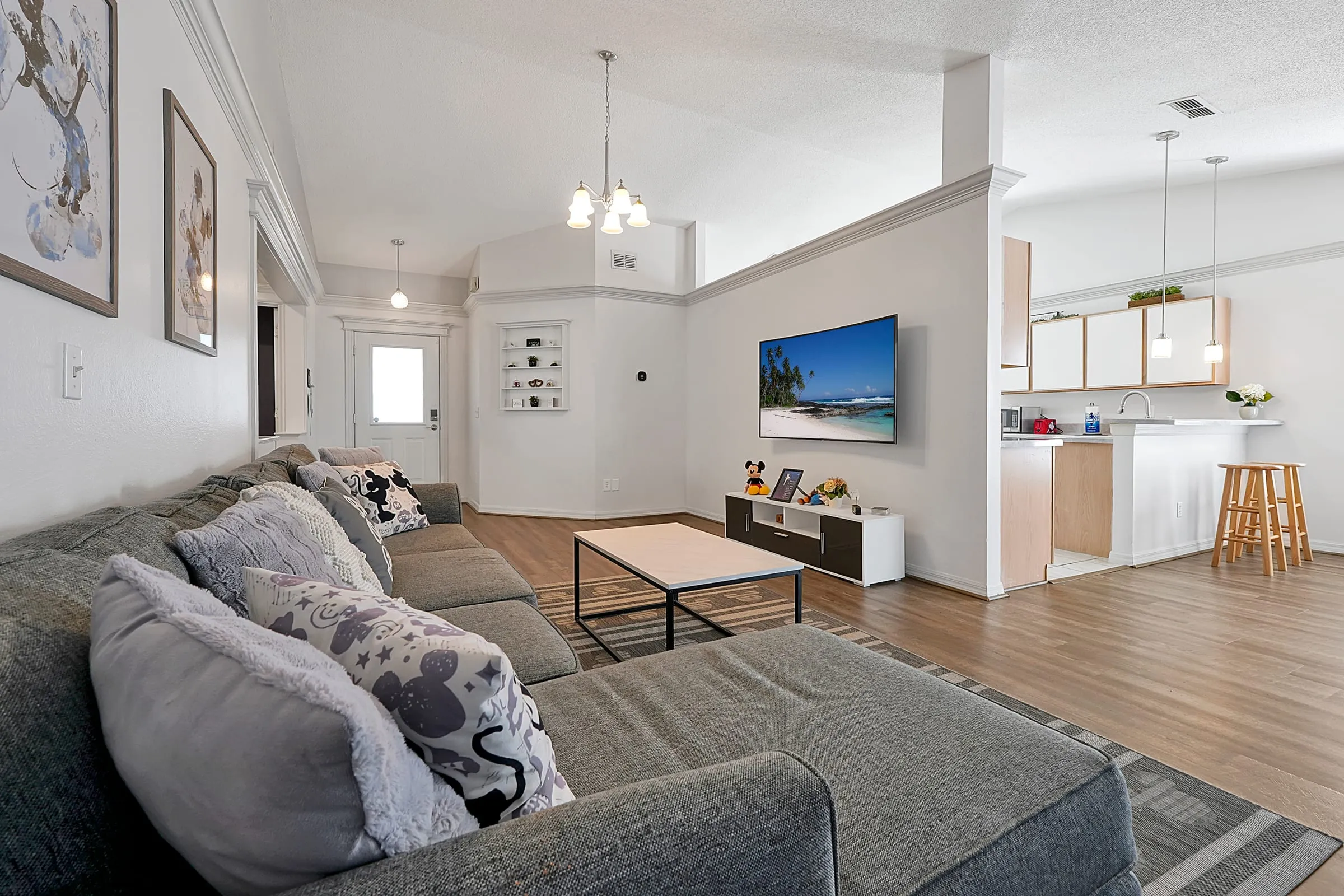 Wide view of the open-plan living, kitchen, and entry