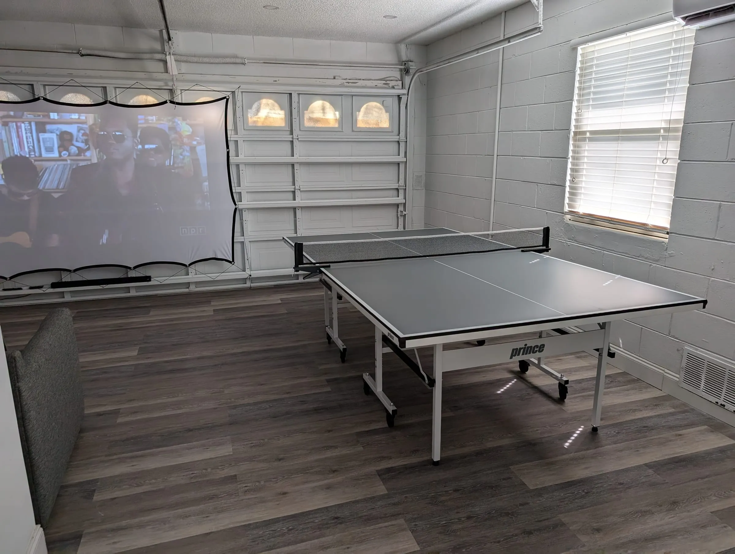 Reverse angle showing the ping-pong table and screen