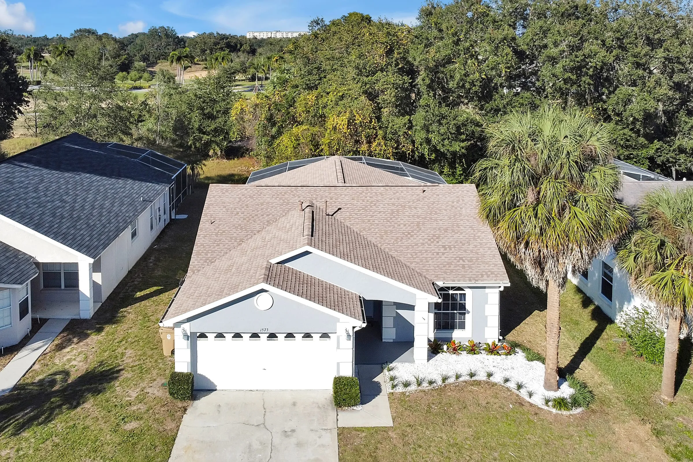 Aerial showing the roof, pool cage, and yard